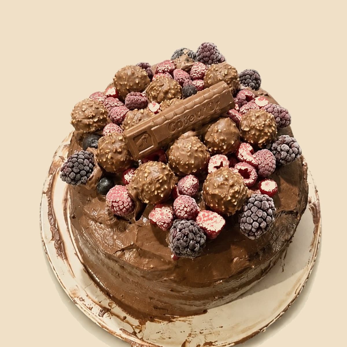 A chocolate cake piled with berries