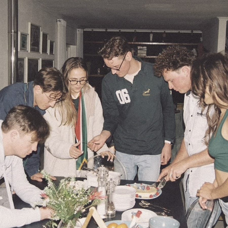 A kitchen full of people, mid-braai
