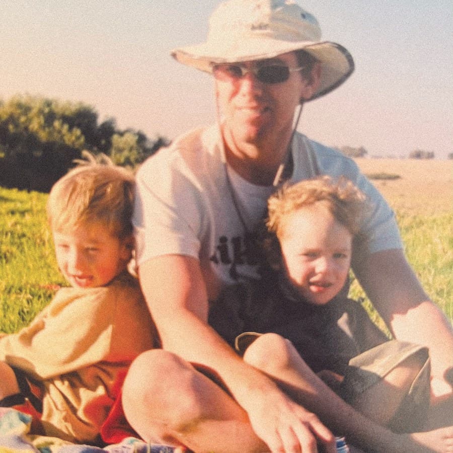 A father and two children in a field