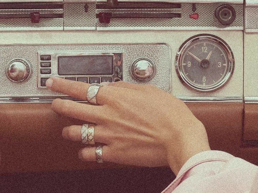 A hand tuning a vintage radio