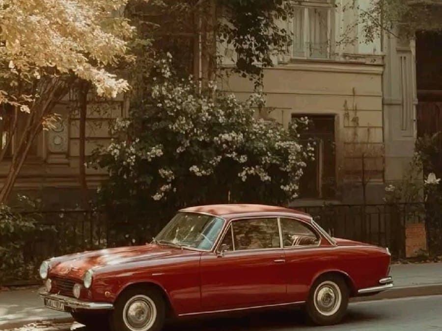 A red car on a spring street